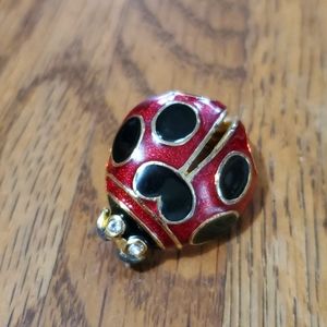 Ladybug brooch of red and black enamel